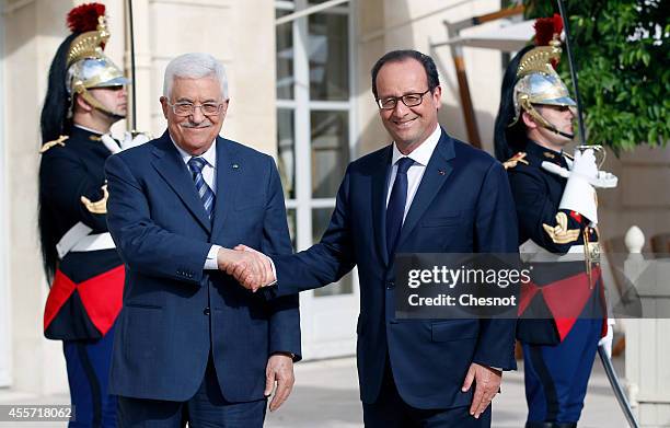 French President Francois Hollande welcomes Palestinian President Mahmoud Abbas prior a meeting at the Elysee presidential palace on September 19 in...