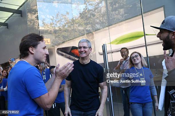 Apple CEO Tim Cook opens the door to an Apple Store to begin sales of the new iPhone 6 on September 19, 2014 in Palo Alto, California. Hundreds of...