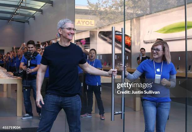 Apple CEO Tim Cook opens the door to an Apple Store to begin sales of the new iPhone 6 on September 19, 2014 in Palo Alto, California. Hundreds of...