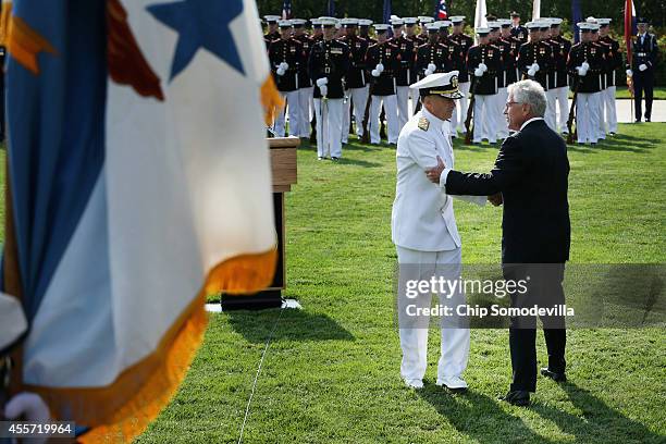 Secretary of Defense Chuck Hagel shakes hands with Vice Chairman of the Joint Chiefs of Staff Adm. James Winnefeld Jr. During the Defense...