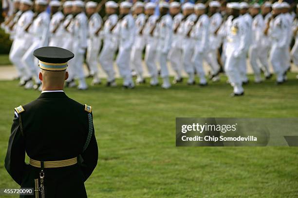 Members of United States military honor guards march during the Defense Department's National POW/MIA Recognition Day Ceremony on the Pentagon River...
