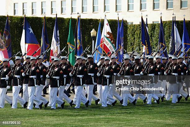 Members of United States military honor guards march during the Defense Department's National POW/MIA Recognition Day Ceremony on the Pentagon River...