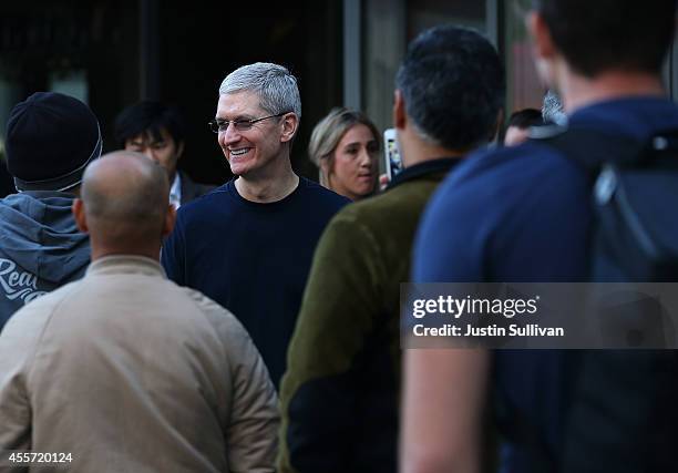 Apple CEO Tim Cook greets people waiting in line to buy the new iPhone 6 at an Apple Store on September 19, 2014 in Palo Alto, California. Hundreds...