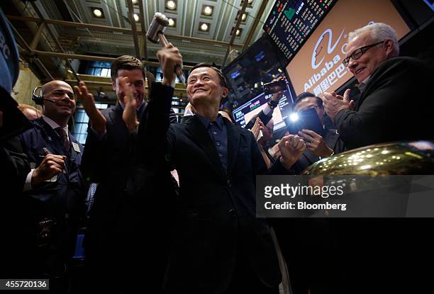 Billionaire Jack Ma, chairman of Alibaba Group Holding Ltd., center, rings a bell during the IPO ceremony on the floor of the New York Stock Exchange...