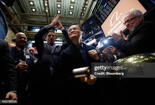 Billionaire Jack Ma, chairman of Alibaba Group Holding Ltd., center, rings a bell during the IPO ceremony on the floor of the New York Stock Exchange...