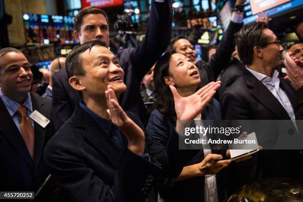 Founder and Executive Chairman of Alibaba Group Jack Ma celebrates as the Alibaba stock goes live during the company's initial price offering at the...