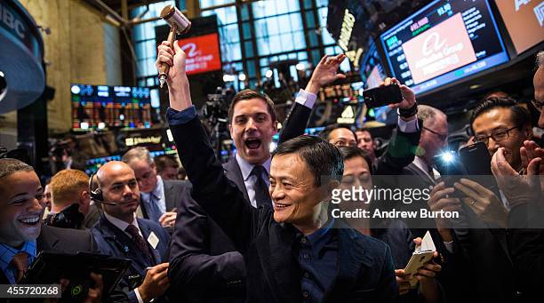 Founder and Executive Chairman of Alibaba Group Jack Ma celebrates as the Alibaba stock goes live during the company's initial price offering at the...