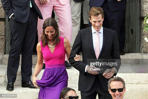 The sister of the Duchess of Cambridge, Pippa Middleton , leaves on September 19, 2014 with an unidentified guest the wedding ceremony of her...