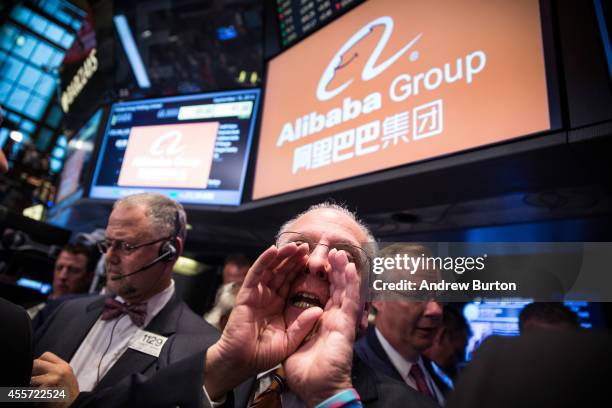 Traders work on the floor of the New York Stock Exchange while the price of Alibaba Group's initial price offering is decided on September 19, 2014...