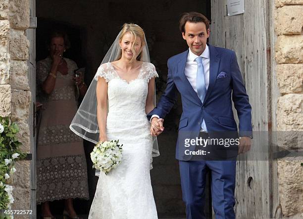 Charlie Gilkes , a British nightclub owner, and Anneke von Trotha Taylor smile at the end of their wedding at Carlo V Castle of Monopoli, on...