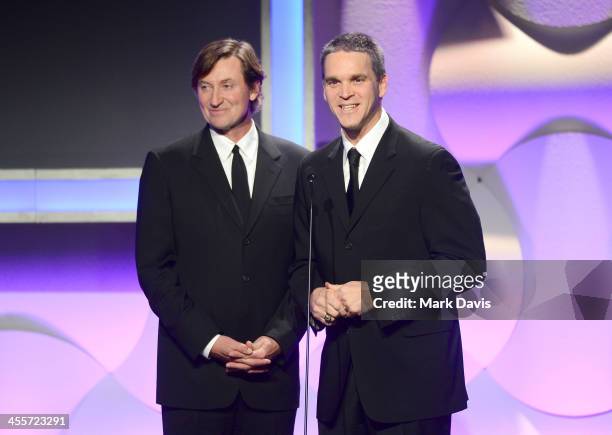 Former NHL player Wayne Gretzky and Los Angeles Kings Business Operations President Luc Robitaille speak onstage during the 27th American...