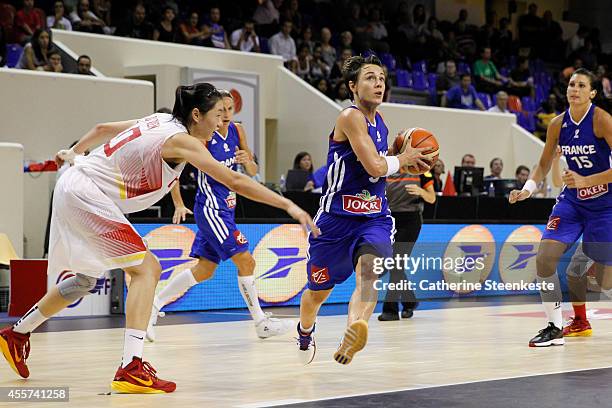 Celine Dumerc of the French Basketball Women's National Team drives to the basket against Lu Weng of the Chinese Basketball Women's National Team...