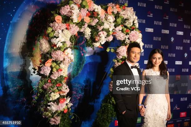 Actor Huang Xiaoming and actress Angelababy attend 2014 Bazaar Charity Night at China World Trade Center Tower III on September 19, 2014 in Beijing,...