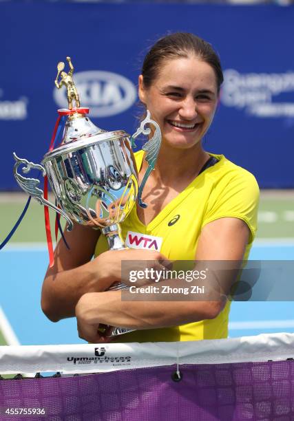Monica Niculescu of Romania victorious with trophy after winning the final match against Alize Cornet of France on day six of the 2014 WTA Guangzhou...