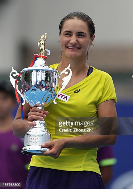 Monica Niculescu of Romania victorious with trophy after winning the final match against Alize Cornet of France on day six of the 2014 WTA Guangzhou...