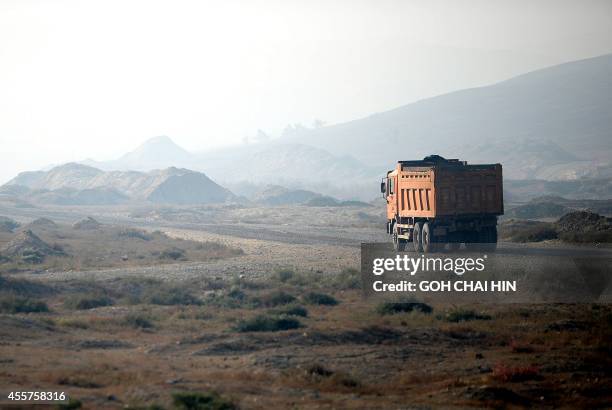 This picture taken on September 18, 2014 shows a truck carries ores from a quarry in the outskirts of Urumqi, farwest China's Xinjiang region....