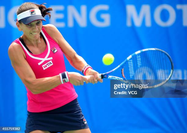 Chanelle Scheepers of South Africa returns a ball in the qualifying match against Timea Bacsinszky of Switzerland prior to the start of 2014 WTA...