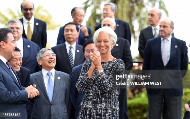 Head of the IMF Christine Legarde shares a lighter moment with other delegates before posing for a group photograph at the G20 Finance Ministers and...