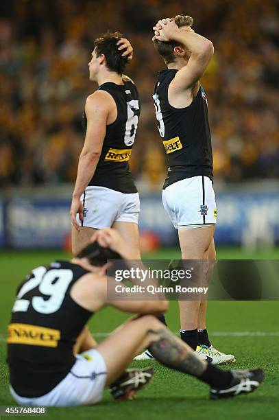 Angus Monfries, Jasper Pittard and Robbie Gray of the Power look dejected after losing the AFL 2nd Preliminary Final match between the Hawthorn Hawks...