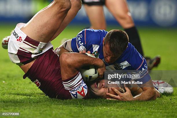 Josh Reynolds of the Bulldogs tackles Brett Stewart of the Sea Eagles during the NRL 2nd Semi Final match between the Manly Sea Eagles and the...