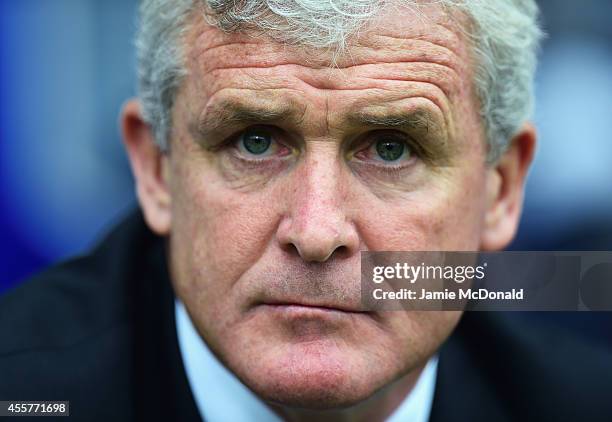 Mark Hughes, manager of Stoke City looks on during the Barclays Premier League match between Queens Park Rangers and Stoke City at Loftus Road on...