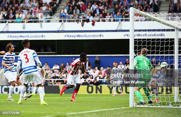 Mame Biram Diouf of Stoke City scores the opening goal during the Barclays Premier League match between Queens Park Rangers and Stoke City at Loftus...