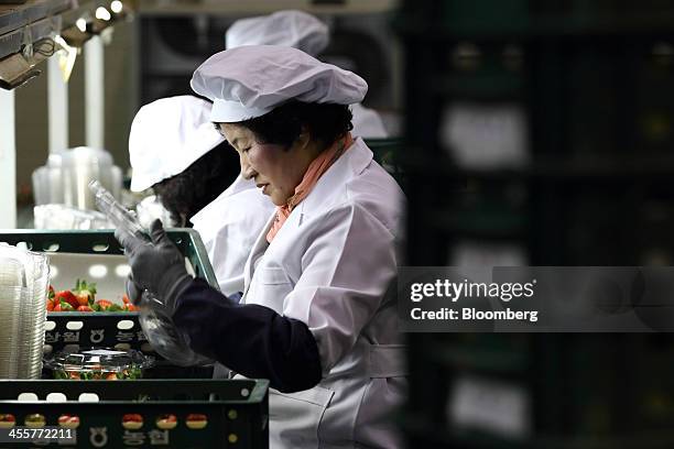 Workers pack strawberries at a packing warehouse, operated by the National Agricultural Cooperative Federation , in Nonsan, South Chungcheong...