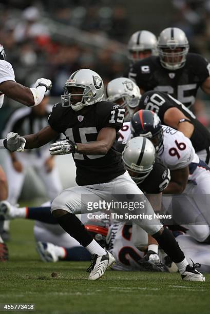 Justin Fargas of the Oakland Raiders is tackled by Tim Crowder of the Denver Broncos during a game on December 2, 2007 at the McAfee Coliseum Stadium...