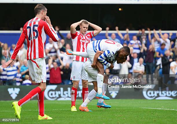 Steven Caulker of QPR is congratulated by Leroy Fer after scoring his team's opening goal during the Barclays Premier League match between Queens...