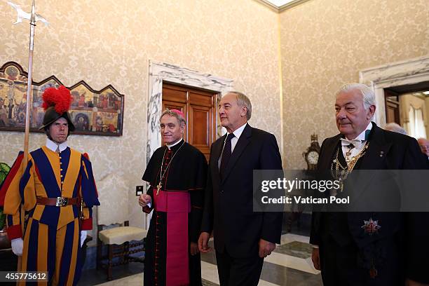 President of Latvia Andris Berzins flanked by Prefect of the Pontifical House and former personal secretary of Pope Benedict XVI, Georg Ganswein...