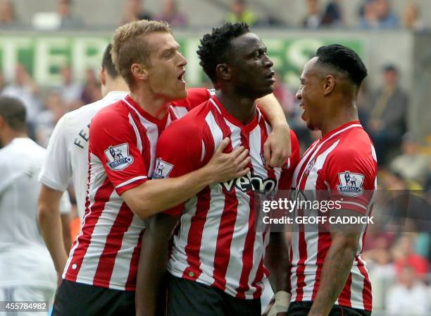 Southampton's Kenyan midfielder Victor Wanyama is congratulated by teammates after scoring the only goal of the English Premier League football match...