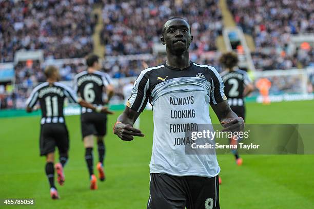 Papiss Cisse of Newcastle celebrates by lifting his shirt in support of team mate Jonas Guiterrez after scoring his second goal during the Barclays...