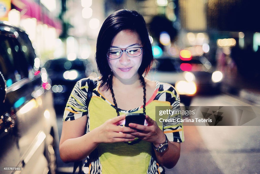 Indonesian woman on the phone at night