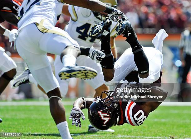 Wide receiver Demitri Knowles of the Virginia Tech Hokies gets flipped upside down on a kick off return against the Georgia Tech Yellow Jackets in...