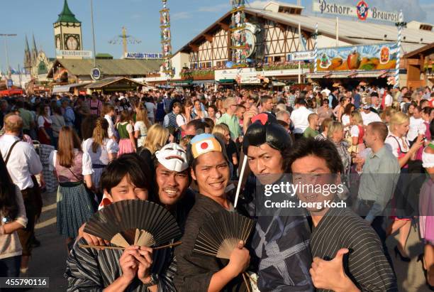 Visitors from Tokyo, Japan, pose during the opening day of the 2014 Oktoberfest on September 20, 2014 in Munich, Germany. Oktoberfest is the world's...