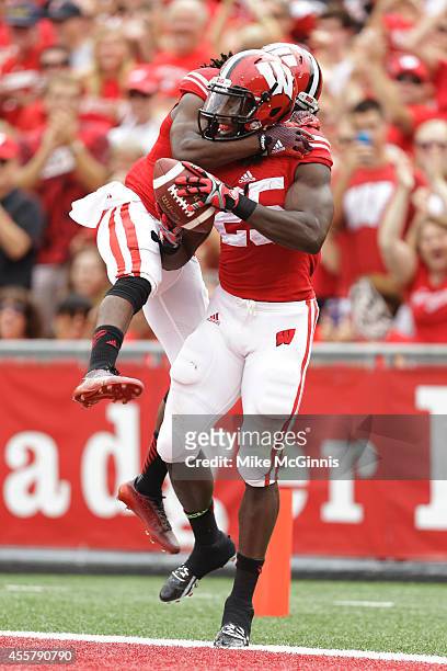 Melvin Gordon of the Wisconsin Badgers celebrates with Kenzel Doe after scoring a touchdown during the second quarter against the Bowling Green...