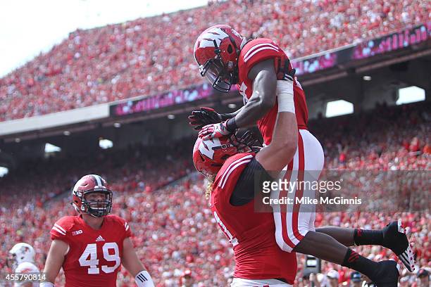 Melvin Gordon of the Wisconsin Badgers celebrates after scoring a touchdown during the first quarter against the Bowling Green Falcons at Camp...