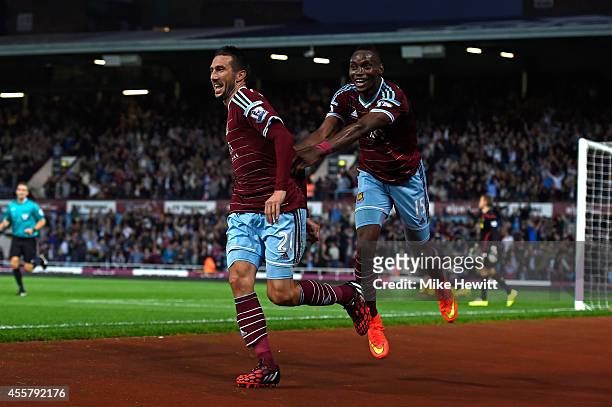 Morgan Amalfitano of West Ham celebrates with teammate Diafra Sakho of West Ham after scoring his team's third goal during the Barclays Premier...