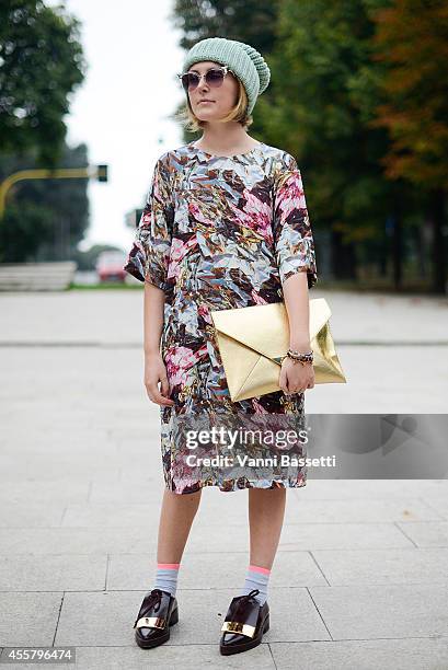 Fabrizia Siena poses wearing Other stories hat, Fendi sunglasses, Marni dress and shoes and H and M bag on September 20, 2014 in Milan, Italy.