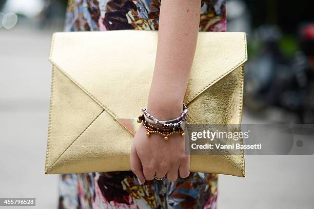 Fabrizia Siena poses wearing Fendi sunglasses, Marni dress and H and M bag on September 20, 2014 in Milan, Italy.