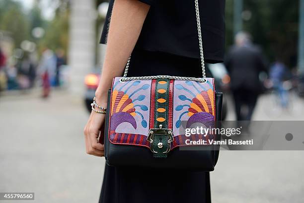 Linda Tol wears an Annie P dress and Paula Cademertaori bag on September 20, 2014 in Milan, Italy.