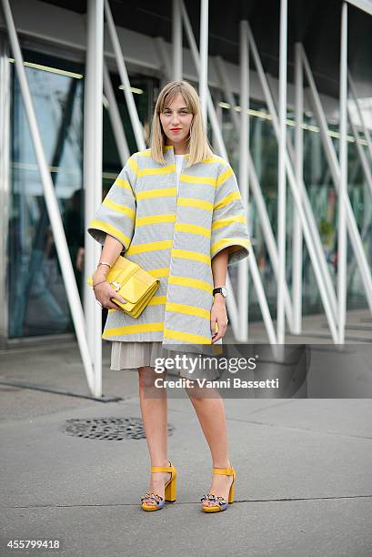 Margherita Ronelli poses wearing Stella Jean coat, COS skirt, Paula Cademartori bag and Max and Co shoes on September 20, 2014 in Milan, Italy.