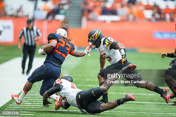 Running back Prince-Tyson Gulley of the Syracuse Orange is forced down by linebacker Jalen Brooks of the Maryland Terrapins during the first quarter...