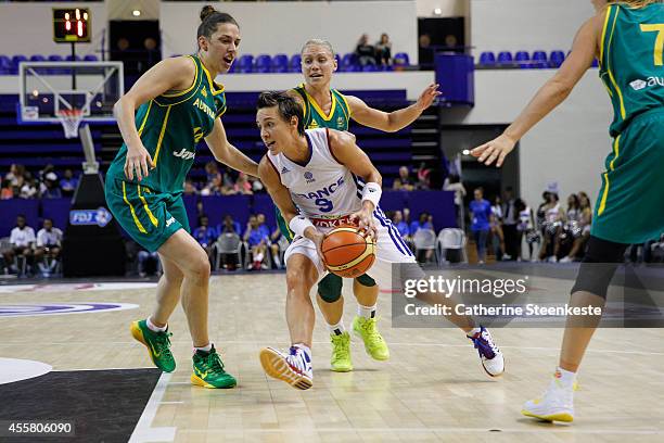 Celine Dumerc of the French Basketball Women's National Team tries to drive to the basket against Marianna Tolo and Erin Phillips of the Australian...