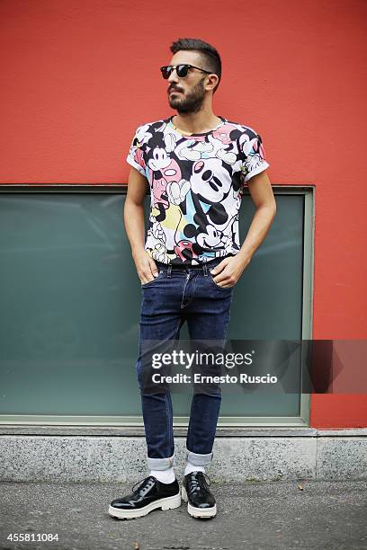 Hugo Rotondo poses wearing a Bershka t-shirt, Camper shoes and Ray Ban sun glasses during the Armani fashion Show as a part of Milan Fashion Week...