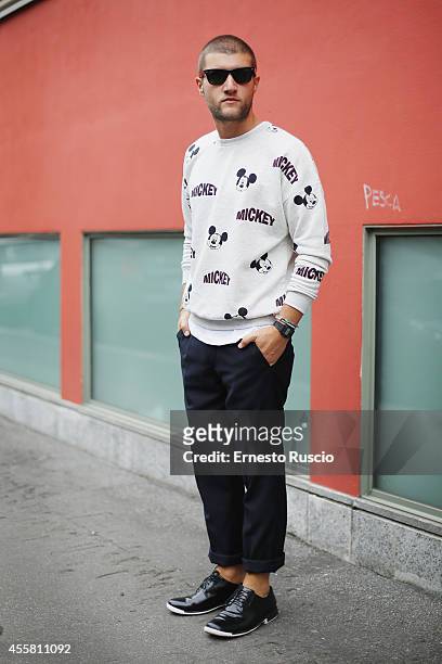 Luigi Frajese poses wearing a Bershka t-shirt, Camper shoes and Ray Ban sun glasses during the Armani fashion Show as a part of Milan Fashion Week...