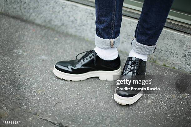 Hugo Rotondo poses wearing a Bershka t-shirt, Camper shoes and Ray Ban sun glasses during the Armani fashion Show as a part of Milan Fashion Week...