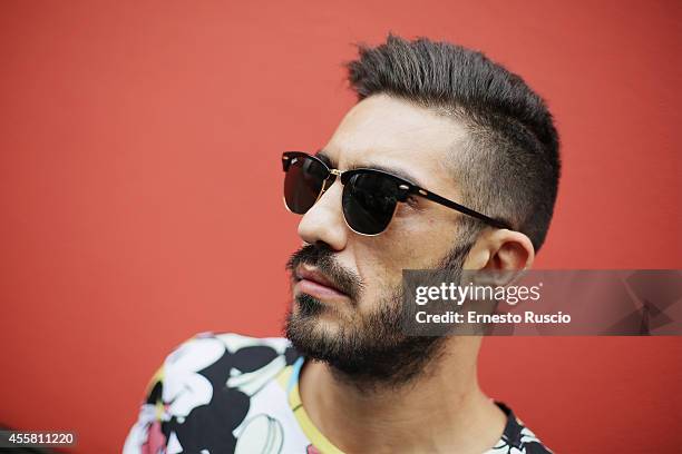 Hugo Rotondo poses wearing a Bershka t-shirt, Camper shoes and Ray Ban sun glasses during the Armani fashion Show as a part of Milan Fashion Week...