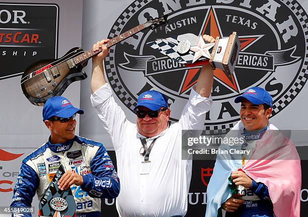 Team owner Chip Ganassi, C, celebrates with his drivers Scott Pruett, L, and Memo Rojas after winning the Lone Star Le Mans at Circuit of The...