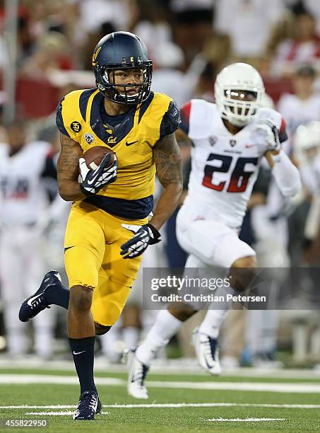 Wide receiver Bryce Treggs of the California Golden Bears runs with the football en route to scoring a 80 yard touchdown reception past safety...